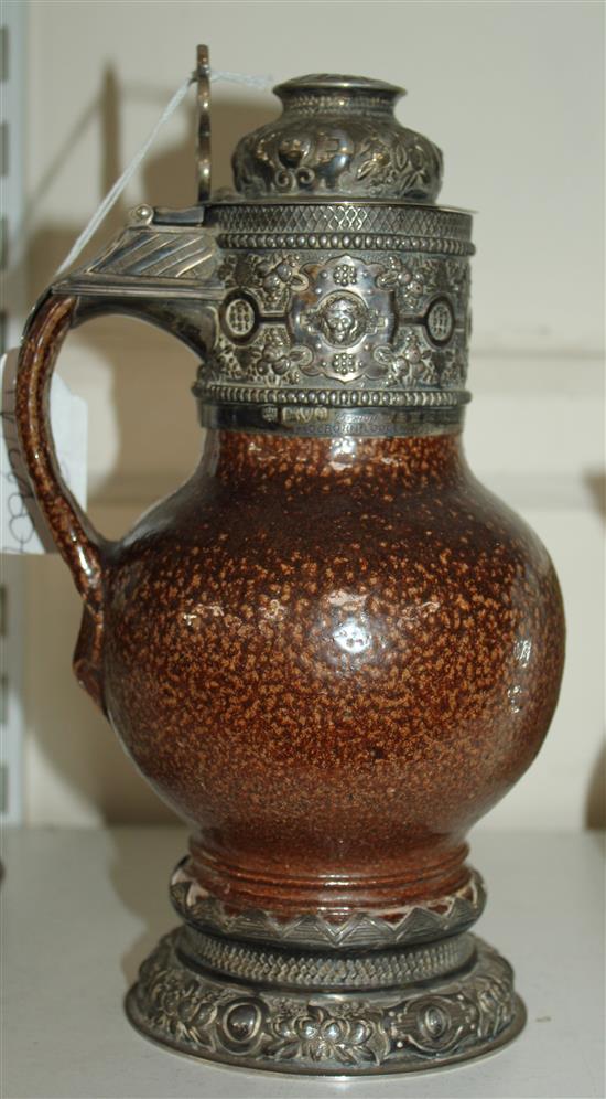 An Elizabethan style tiger ware jug, George V silver mounts, 9.75in.